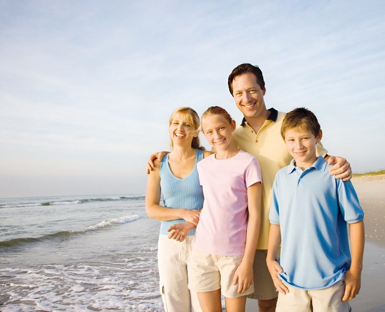Smiling family on beach.